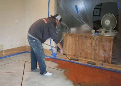 Professional applying LastiSeal Concrete Stain & Sealer.