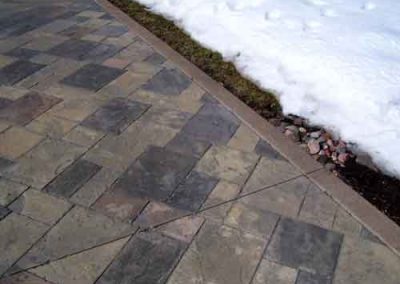 Color stain applied to driveway pavers.