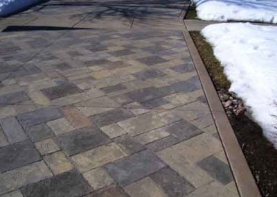 Color stain applied to driveway pavers.