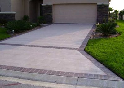 Semi-translucent stain and penetrating sealer applied to concrete driveway.