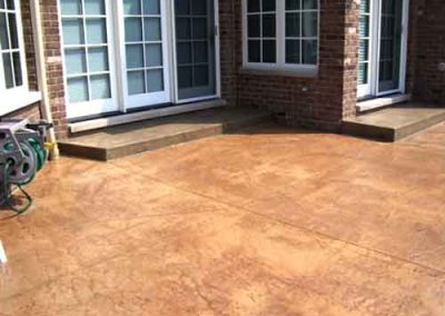 Concrete staining an outdoor patio slab.